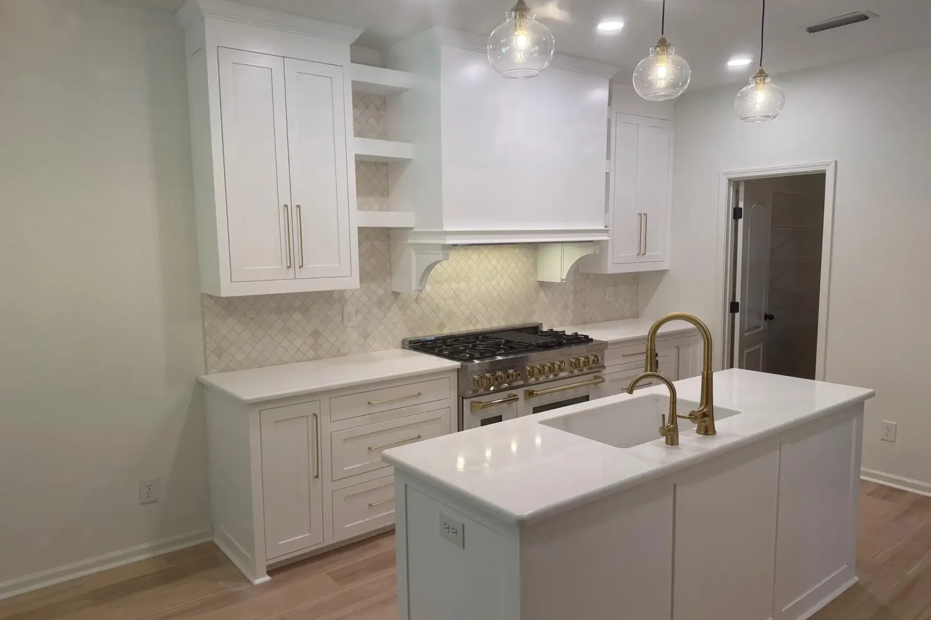 Dorsey custom kitchen design with white cabinetry, gold hardware, and quartz countertops in Dothan, Alabama.