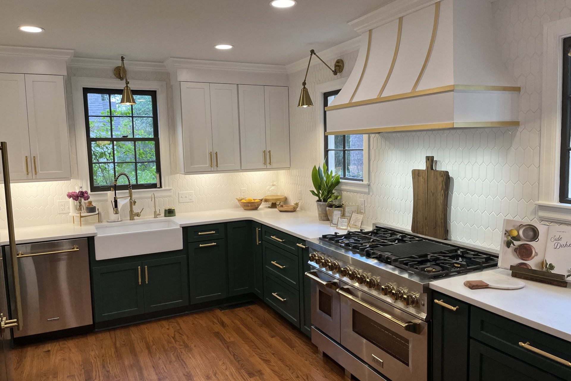 Custom kitchen remodel with farmhouse sink, two-tone cabinetry, brass hardware, modern pendant lighting, and luxury range by Dorsey Builders in Dothan, Alabama.
