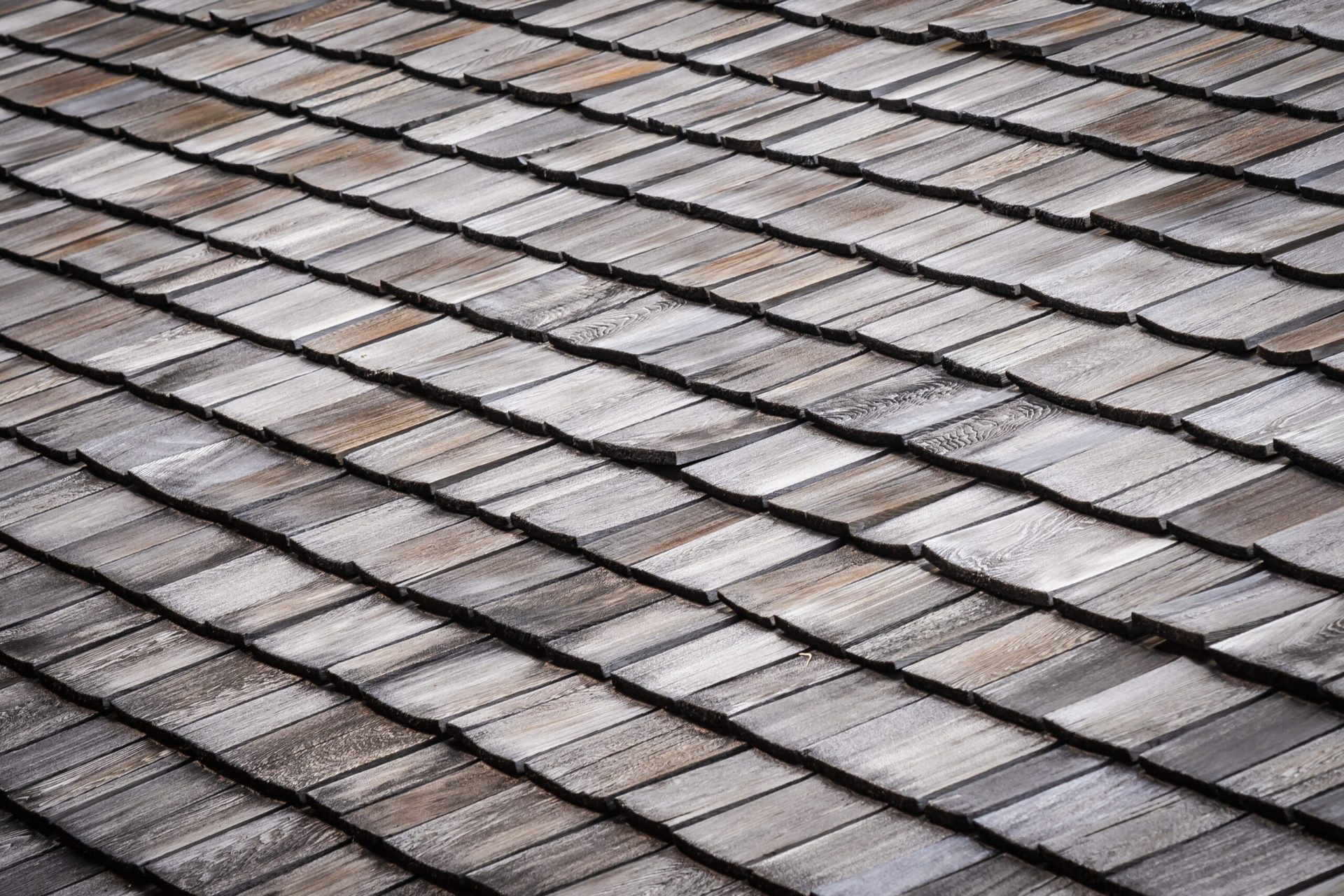 Close-up detail of rustic wood shake roofing installed by Dorsey Builders, roofing and exterior experts in Dothan, Alabama.